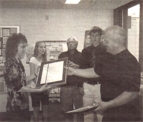 Mark Rusk Presents a Framed Message to Melanie Boeck